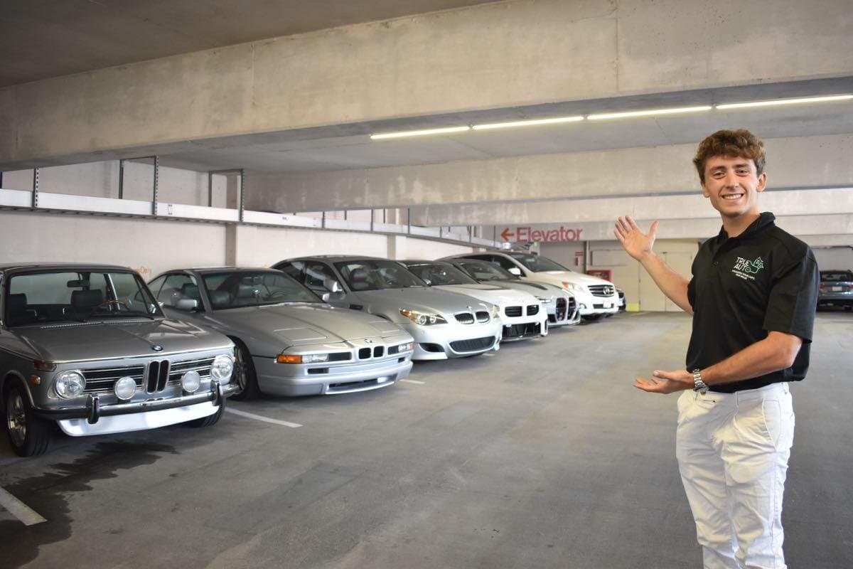 Alex Gaffney, founder of TrueAuto, with a row of consignment vehicles